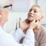 Doctor checking size of lymph nodes