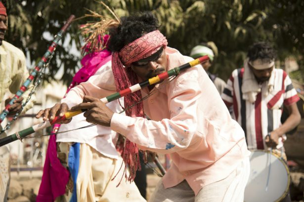 Tribal man perform music.